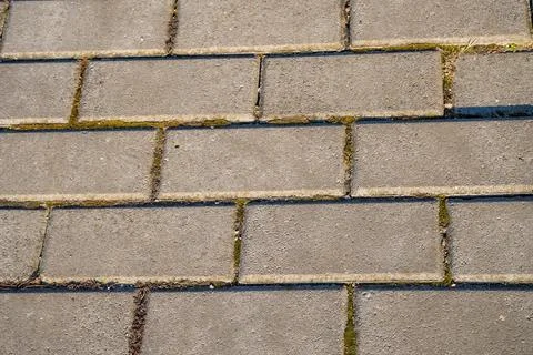 Grey brick pavement background close up. Gray stone tile block background Stock Photos