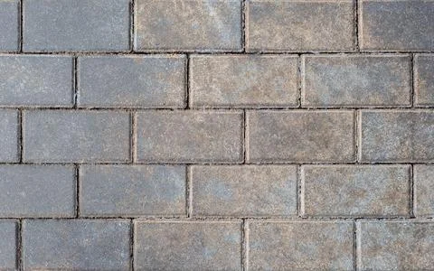 Grey brick wall background close up. Gray stone tile block background with ho Stock Photos