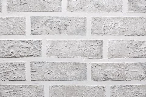 Grey brick wall imitation texture. White and beige plaster background. Illustrazione stock