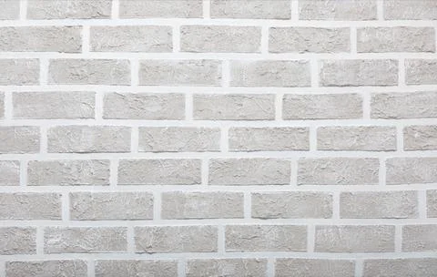 Grey brick wall imitation texture. White and beige plaster background. Illustrazione stock