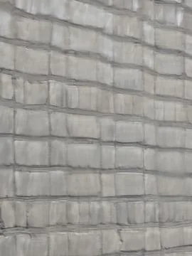 Grey brick wall texture through wet window. Stock Photos