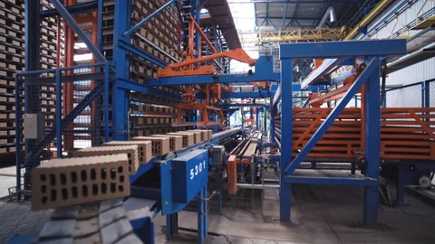 Grey bricks are moving on a manufacturing line on the fully automated factory Stock Footage 128161393