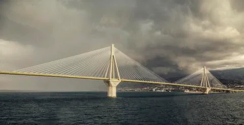 Grey bridge under rain clouds at sea Stock Photos