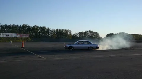 Grey car drifts around long corner at drifting event on closed course. Stock Footage 59747554