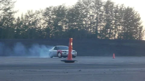 Grey car drifts around pylon on drifting race course. Stock Footage 59762036