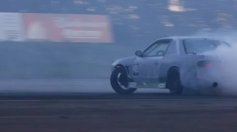 Grey car drifts rapidly around corner at drifting event. Stock Footage 59762367