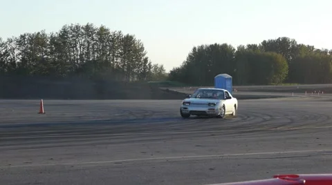 Grey car screeches around corner at drifting practice event. Stock Footage 59747538