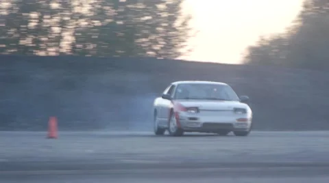 Grey car whips around corner on closed course at drift racing event. Stock Footage 59762200