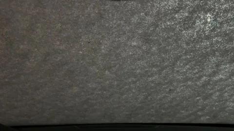 A grey car windshield with a white paper on it Vidéo 275326113