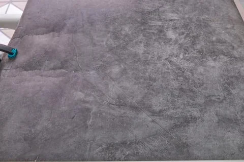 A grey carpet with a blue object on it Stock Photos