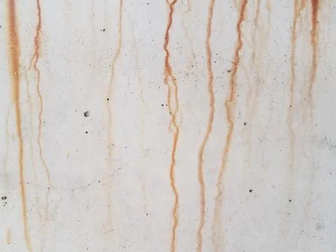 Grey cement wall with red rust dripping down Stock Photos