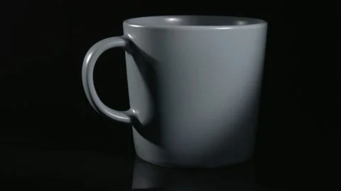 Grey ceramic cup close-up on a black background. Stockbeeldmateriaal 147097958
