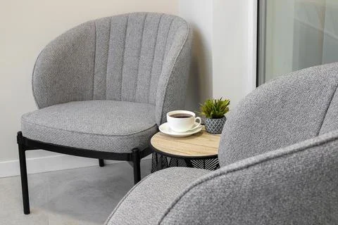 Grey chairs with table in the interior Fotos Stock