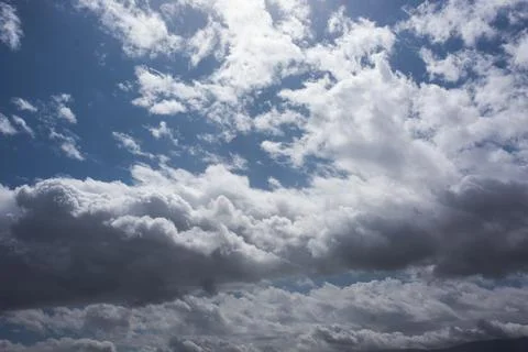 Grey clouds in a blue sky Stock Photos
