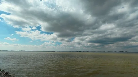 Grey clouds loom above rippling brown waters. Ram Fortress, Serbia Видео 332543483