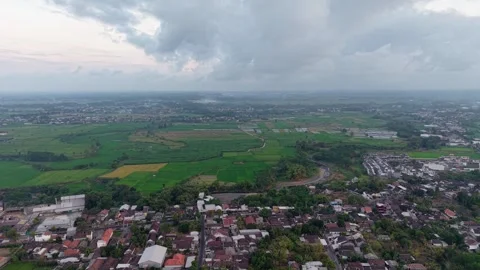 Grey clouds loom over sprawling green fields Stock Footage 346257534