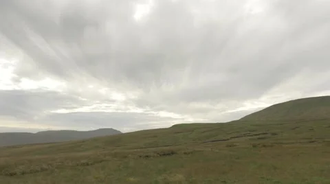 Grey Clouds Over Grassy Mountain Peaks Stock Footage