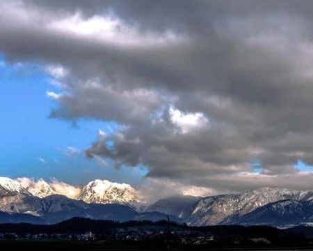 Grey clouds over the mountains in the background Stock Photos