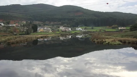 Grey clouds reflected in Fazouro river in Spain Stock Footage 324681749