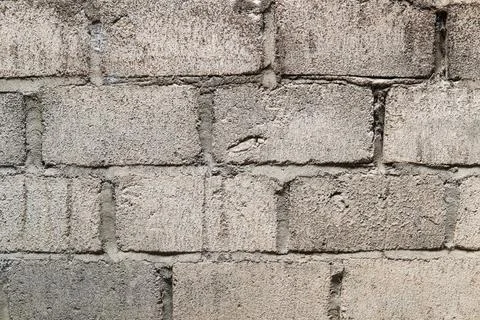 A grey colored brick wall with a pattern of squares. Stock Photos