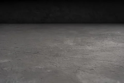Grey concrete background with a dark backdrop for the placement of objects an Stock Photos