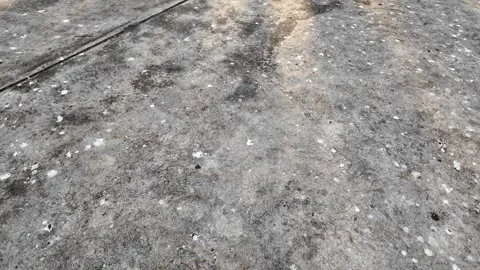 A grey concrete floor with many small holes Vidéo 325823677