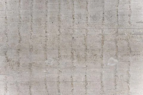 Grey concrete wall texture background with grid pattern of grooves Stock Photos