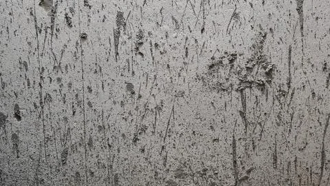 Grey concrete wall texture with dark vertical grunge stains and weathered cement Stock Photos