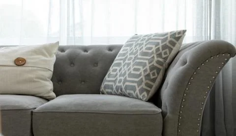 Grey couch with throw pillows Stock Photos