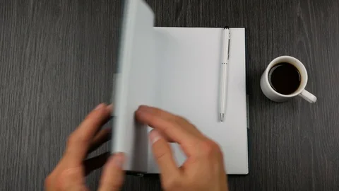 Grey covered notepad and cup of cofee on dark wooden background. Stock-Footage 98606290