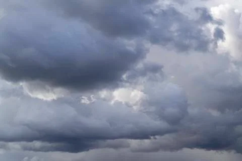 Grey cumulus clouds on blue sky before rain. Stock Photos