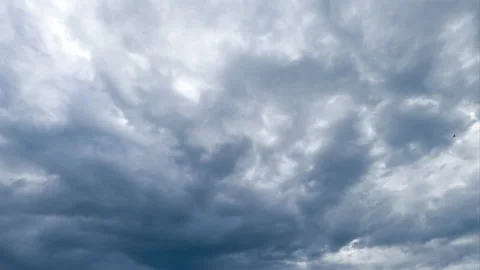 Grey dramatic cloudscape shading the sun. Cumulus clouds gathering Video stock 209260794