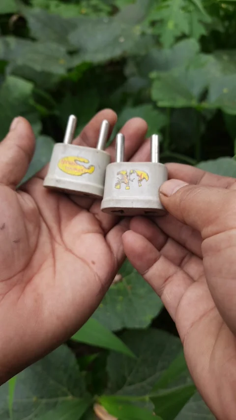 Grey electrical plug adapters, plastic utility connectors with metal prongs.. 스톡 동영상 345114711