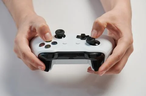 Grey game controller in hand Stock Photos