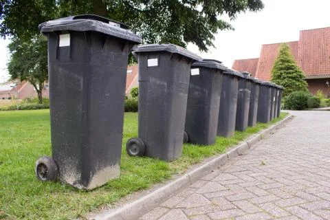 Grey garbage containers in a row Stock Photos