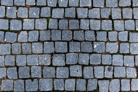Grey granite cobblestone pavement texture background top view Stock Photos