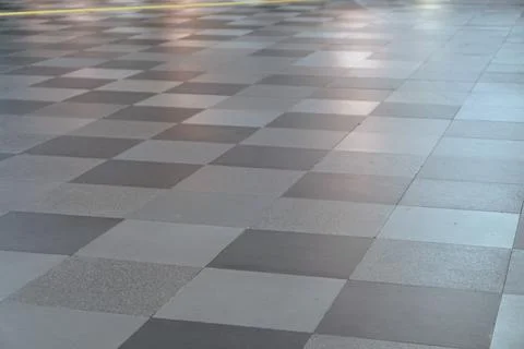 Grey granite tile checkered pattern on modern building floor surface Stock Photos