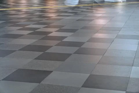 Grey granite tile checkered pattern on modern building floor surface Stock Photos