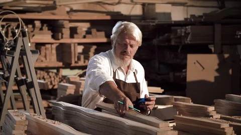 Grey-haired Carpenter’s hands are holding a ruler and a pencil. Carpenter Stock Footage 112628044