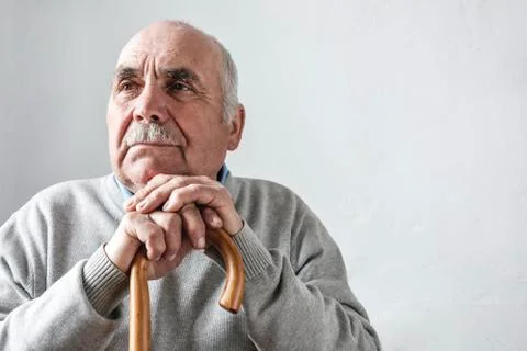 Grey haired elderly man with mustache thinking Stock-Fotos