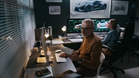 Grey-Haired Male Car Engineer Creating Computer Render of Scaled Model Stock Footage 304424596