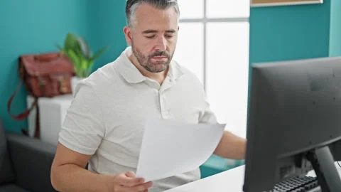 Grey-haired man business worker wearing glasses working at the office Video stock 246992604