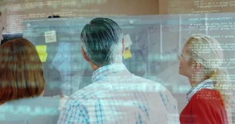 Grey-haired man stepping placing sticky notes on board and code overlay driving Stock Footage 311901272