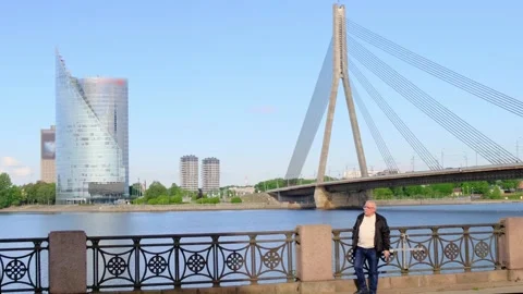 Grey haired man takes gadget and starts talking on phone Stock Footage 136426950