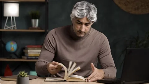 Grey Haired Middle Aged Male Scholar Reading a Book in Home Office Stock Footage 342236563