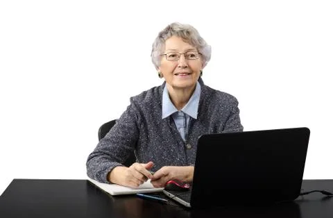 Grey haired old lady talking in skype 库存照片