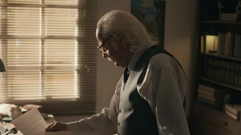 Grey haired Writer Checking Typewritten Script Pages in Retro Office 스톡 동영상 312150130