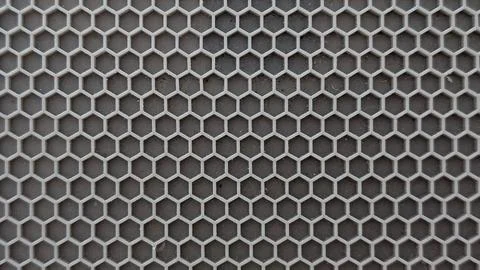 Grey hexagonal honeycomb grid pattern filling the frame Stock Photos