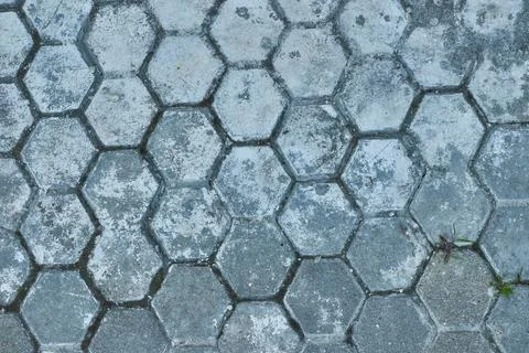 Grey hexagonal paving tiles. Textured concrete pavement blocks. Old stone h.. Stock Photos