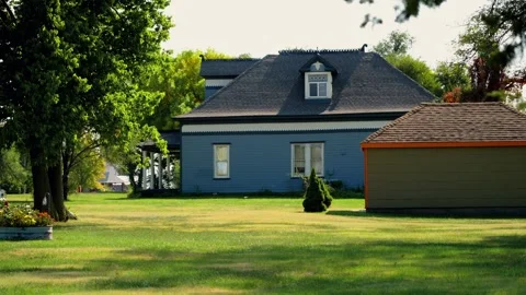 A grey house with a front lawn and trees in Lebanon Stock Footage 345530569